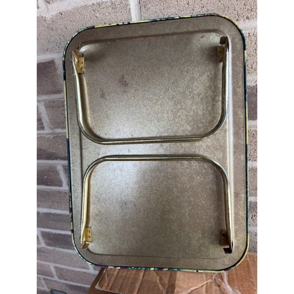 Vintage metal TV tray set features a vibrant 1960s or 70s floral pattern